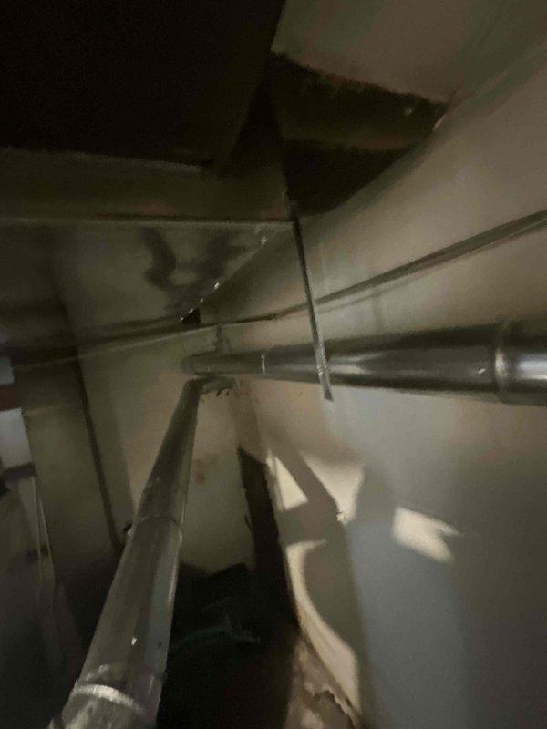 Conducted comprehensive site evaluation for complete air conditioning system replacement at residential property. Assessed existing ductwork configuration, measured available installation space in confined utility area, and documented current system layout including vertical duct runs and support structures. Provided detailed estimate for new AC unit installation with recommendations for equipment sizing and placement based on existing infrastructure and homeowner timeline requirements.