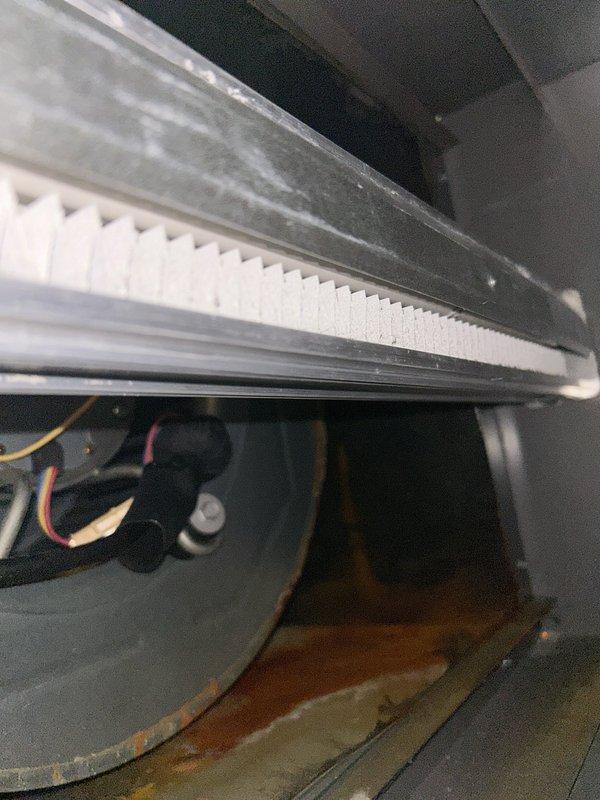 Responded to callback for furnace leaking water and unit not level. Upon inspection, found significant water accumulation and rust-colored staining in the unit's interior compartment, with liquid pooling in the drain pan and visible deterioration on metal surfaces. Documented the ongoing water leak issue with photos showing the extent of moisture damage and condensate management failure requiring further corrective action to resolve the leveling and drainage problems.