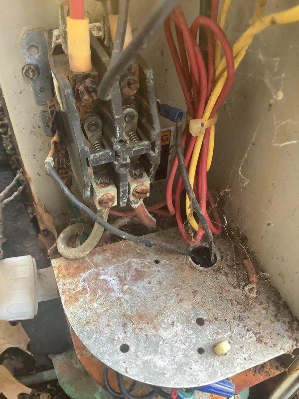 Responded to complaint of air conditioning unit not shutting off on 15-year-old system located on east side of property. Upon inspection, discovered severely corroded contactor and terminal connections with heavy rust and oxidation throughout the electrical assembly. The contactor showed extensive deterioration from prolonged moisture exposure, with corroded terminals, mounting hardware, and connection points. Despite the advanced corrosion, all wire connections remained intact and the system continued to provide adequate cooling. Identified the failed contactor as the root cause preventing the unit from cycling off properly. Checked out without work performed at customer's request to evaluate repair options given the age and condition of the unit.