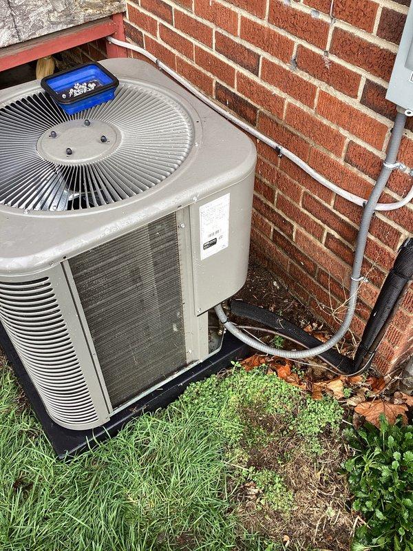 Completed comprehensive ComfortGuard Maintenance Package on residential outdoor air conditioning unit. Performed full system inspection including condenser coil examination, refrigerant pressure diagnostics using digital gauges, verification of proper fan operation, and assessment of drainage system functionality. Unit found to be operating within normal parameters with minor debris accumulation around base requiring attention to maintain optimal airflow and efficiency.
