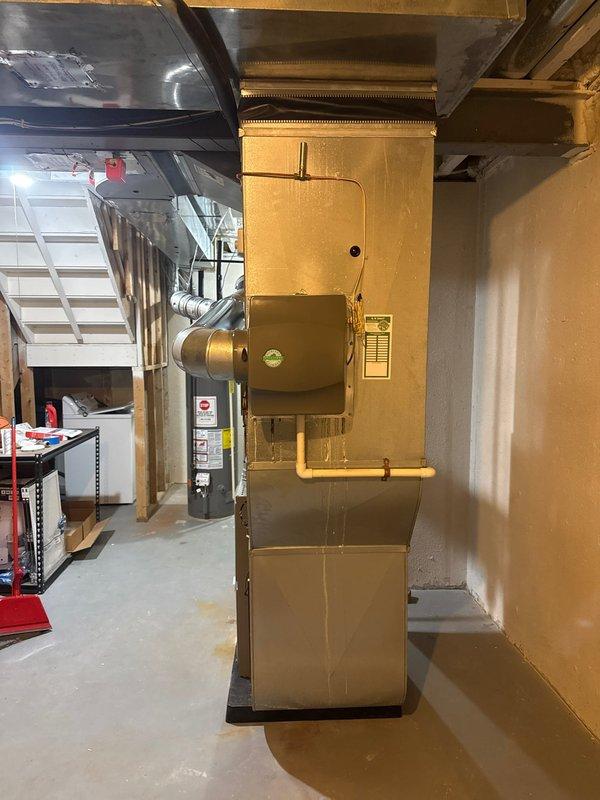 Installed 17-gallon whole-home humidifier unit integrated with existing forced-air furnace system in basement mechanical room. Connected humidifier to main supply ductwork with proper mounting and electrical hookup, ensuring optimal humidity distribution throughout the residence. Installation completed without requiring permits or rebate applications, with system tested and operational upon completion.