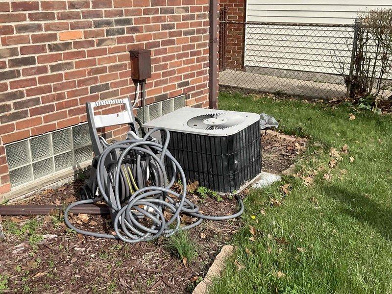 Conducted comprehensive site evaluation for complete HVAC system replacement of 30-year-old furnace and air conditioner. Assessed existing outdoor condensing unit positioned against brick foundation, documented electrical service configuration including dual meter assembly and panel boxes, and evaluated installation accessibility. Photographed current equipment placement, electrical infrastructure, and site conditions to provide accurate replacement estimate for both heating and cooling systems.