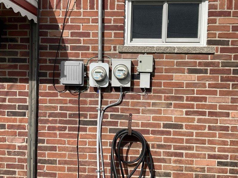 Conducted comprehensive site evaluation for complete HVAC system replacement of 30-year-old furnace and air conditioner. Assessed existing outdoor condensing unit positioned against brick foundation, documented electrical service configuration including dual meter assembly and panel boxes, and evaluated installation accessibility. Photographed current equipment placement, electrical infrastructure, and site conditions to provide accurate replacement estimate for both heating and cooling systems.