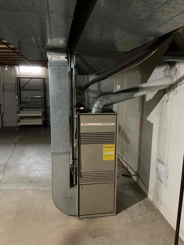 Completed comprehensive full system estimate for residential HVAC replacement. Evaluated existing 16-year-old furnace located in basement mechanical room and 16-year-old air conditioning condenser unit positioned on exterior pad against brick foundation. Documented current equipment condition, assessed ductwork configuration including flex connections and insulated supply runs, and photographed both indoor and outdoor components to provide accurate replacement recommendations for customer seeking seasonal system upgrade.