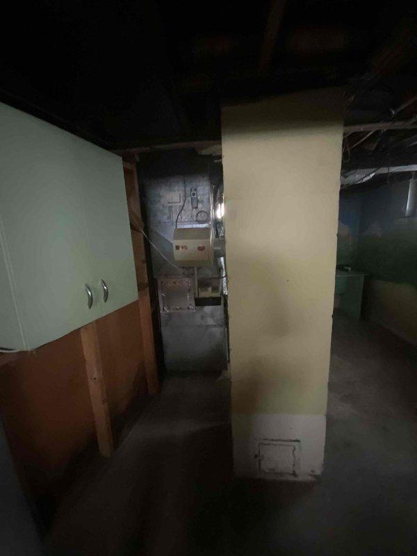 Provided estimate for complete HVAC system replacement in basement location, including furnace and air conditioning unit under BOGO promotion. Existing 15-year-old furnace currently operational but nearing end of service life, with air conditioning system exceeding 30 years and requiring replacement. Equipment located in unfinished basement mechanical room with concrete floor, exposed ceiling joists, and existing ductwork infrastructure in place.