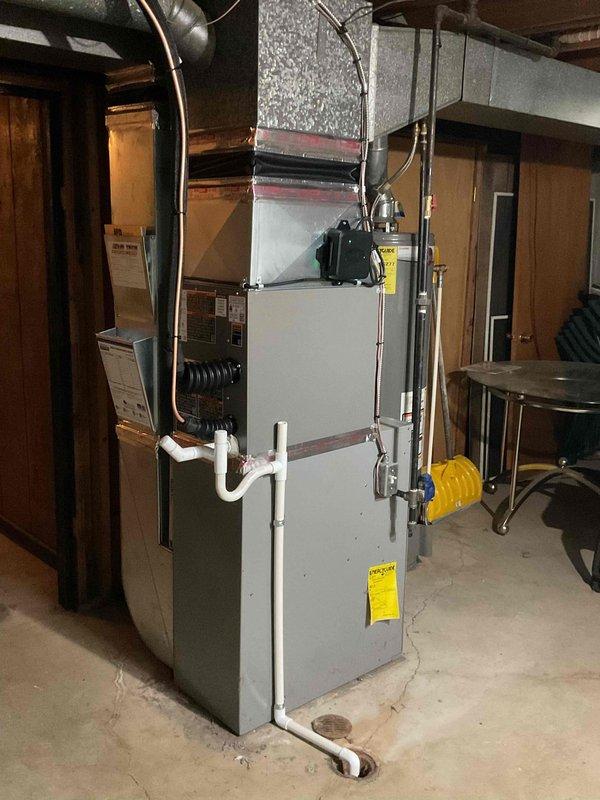 Completed installation of 2-ton air conditioning system with matching evaporator coil. Installed outdoor condenser unit on deck-mounted pad with proper electrical disconnect and reconnected to existing furnace system in basement. System positioned in rear location with refrigerant lines run between indoor and outdoor components. Verified all electrical connections, tested system operation, and ensured proper airflow through new coil integrated with existing ductwork. Installation completed per mechanical permit specifications with all components functioning within manufacturer specifications.