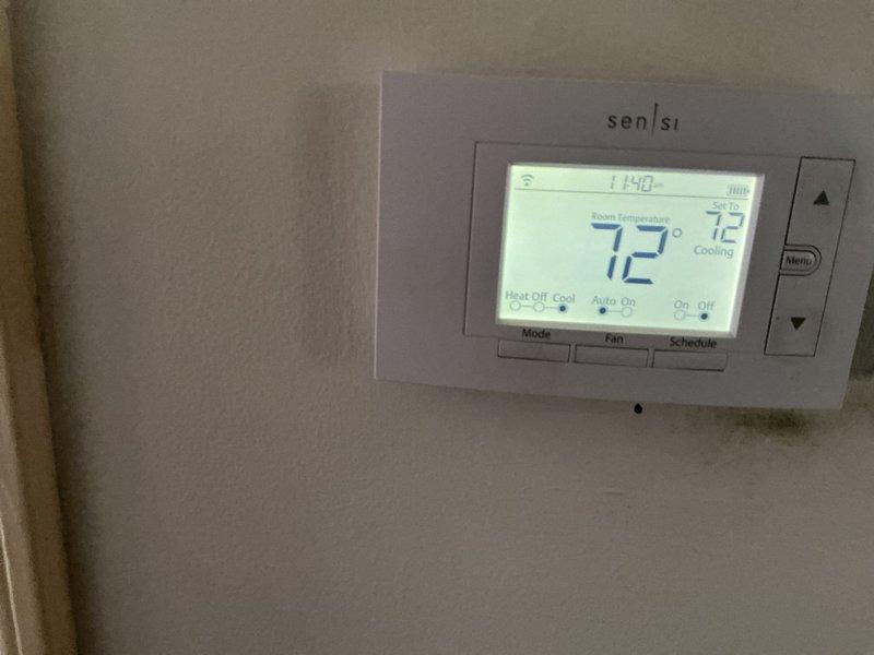 Completed routine ComfortGuard maintenance visit on residential HVAC system. Performed system diagnostics using testing equipment, verified thermostat operation and calibration on Sensi digital programmable unit displaying proper cooling mode functionality at 72°F setpoint, and conducted standard inspection of indoor air handling equipment including wiring connections and component assessment.