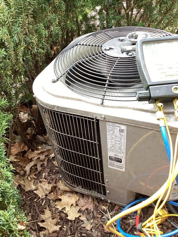 Completed annual preventative maintenance on residential outdoor condensing unit. Performed comprehensive system inspection, verified proper operation of all components including fan motor and compressor, checked refrigerant lines for integrity, and documented unit condition with photos showing equipment in functional state with minor outdoor weathering consistent with normal exposure.