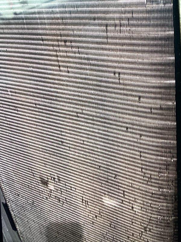 Completed scheduled ACM maintenance on outdoor condensing unit. Condenser coils exhibited heavy accumulation of dirt, dust, pollen, and debris significantly restricting airflow through the fins. Cleaned and serviced unit, replaced air filter and evaporative cooler pad as scheduled.