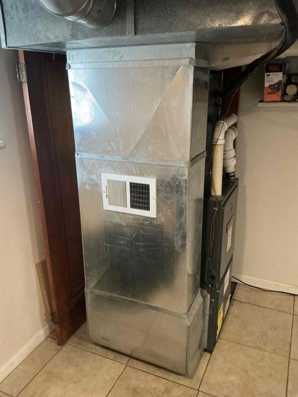 Conducted comprehensive full system HVAC estimate for residential property with 15-year-old air conditioning unit and aging furnace system located in basement utility area. Performed thorough inspection and documentation of existing Goodman furnace showing visible wear, associated ductwork, air handler components, and PVC ventilation piping. Customer expressed interest in complete system replacement within the month, requesting evaluation for combined furnace and AC replacement package due to age of equipment and recommendation from previous property owner regarding AC unit replacement needs.