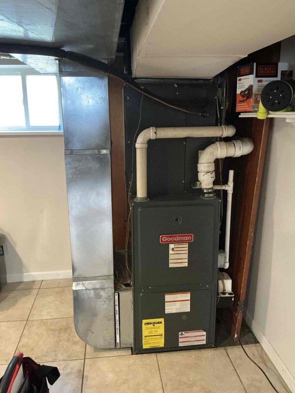 Conducted comprehensive full system HVAC estimate for residential property with 15-year-old air conditioning unit and aging furnace system located in basement utility area. Performed thorough inspection and documentation of existing Goodman furnace showing visible wear, associated ductwork, air handler components, and PVC ventilation piping. Customer expressed interest in complete system replacement within the month, requesting evaluation for combined furnace and AC replacement package due to age of equipment and recommendation from previous property owner regarding AC unit replacement needs.
