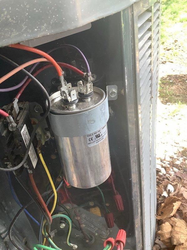 Responded to no-cooling call on 2006 outdoor condensing unit. Upon inspection, found failed dual-run capacitor with visible corrosion on electrical disconnect terminal. Performed electrical diagnostics confirming capacitor failure preventing compressor and condenser fan operation. Replaced defective capacitor, cleaned corroded electrical connections at disconnect, and verified proper voltage and amperage readings. System tested and operating within manufacturer specifications upon departure.