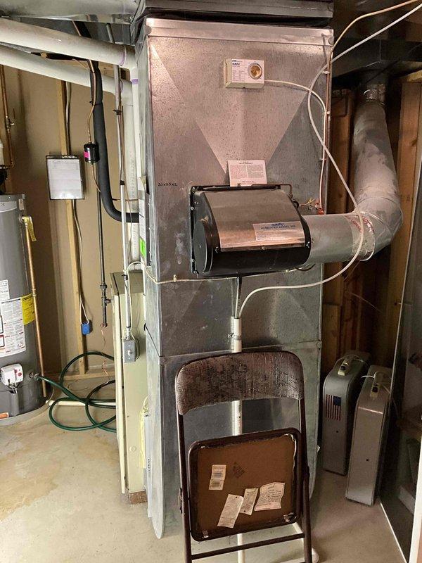 Provided comprehensive estimate for furnace and air conditioning system replacement in basement installation. Current furnace is non-operational while existing air conditioning unit remains functional. Assessed aging HVAC equipment including beige furnace cabinet with exposed internal components, blower motor assembly, and associated ductwork and refrigerant lines. Documented existing system configuration including PVC venting, copper refrigerant tubing, electrical connections, and plenum arrangement. Recommended replacement of both heating and cooling units to ensure brand compatibility and system efficiency. Photographed current equipment conditions showing internal furnace components, air handler assembly, ductwork connections, and mechanical room layout to support estimate preparation.