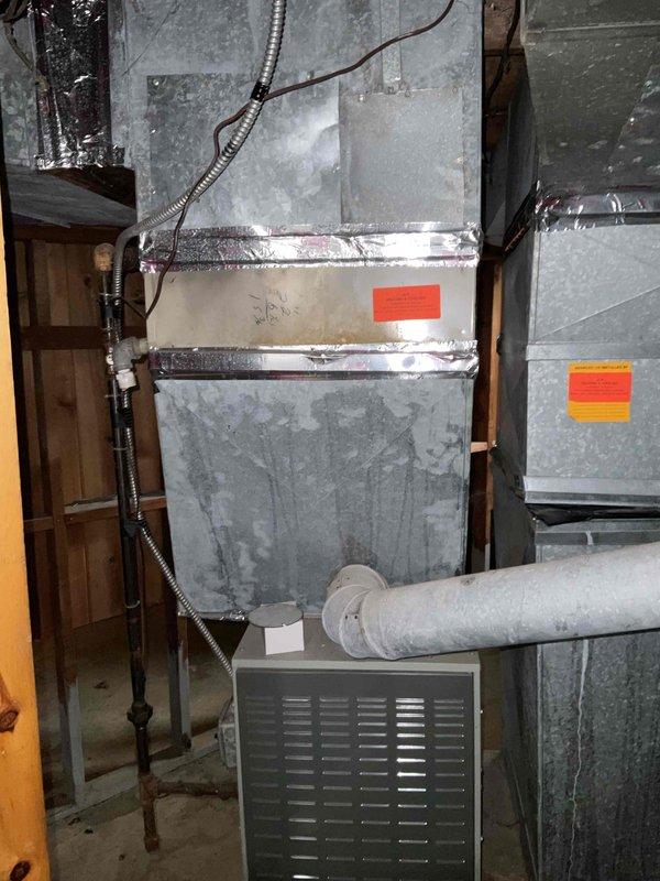 Provided estimate for air conditioning system installation at property currently without AC unit. Assessed basement location housing existing natural gas furnace and evaluated ductwork infrastructure, electrical panel access, and available space for new condensing unit and air handler integration. Documented existing HVAC configuration including sheet metal ductwork, furnace unit, and utility area conditions to determine equipment specifications and installation requirements for complete cooling system addition.