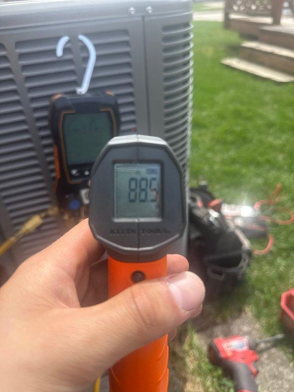 Responded to no-cooling call on 1-month-old outdoor A/C unit. Upon arrival, performed diagnostic testing using digital manifold gauges and infrared thermometer to assess system pressures and temperatures. Readings indicated refrigerant pressures of 117.0 PSI low side and 390.5 PSI high side, with temperature differential measurements confirming system operation. Troubleshot electrical components and verified proper startup sequence. Unit restored to normal operation with all parameters within manufacturer specifications. Warranty coverage applied for parts and labor on this new installation.