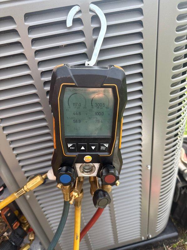 Responded to no-cooling call on 1-month-old outdoor A/C unit. Upon arrival, performed diagnostic testing using digital manifold gauges and infrared thermometer to assess system pressures and temperatures. Readings indicated refrigerant pressures of 117.0 PSI low side and 390.5 PSI high side, with temperature differential measurements confirming system operation. Troubleshot electrical components and verified proper startup sequence. Unit restored to normal operation with all parameters within manufacturer specifications. Warranty coverage applied for parts and labor on this new installation.