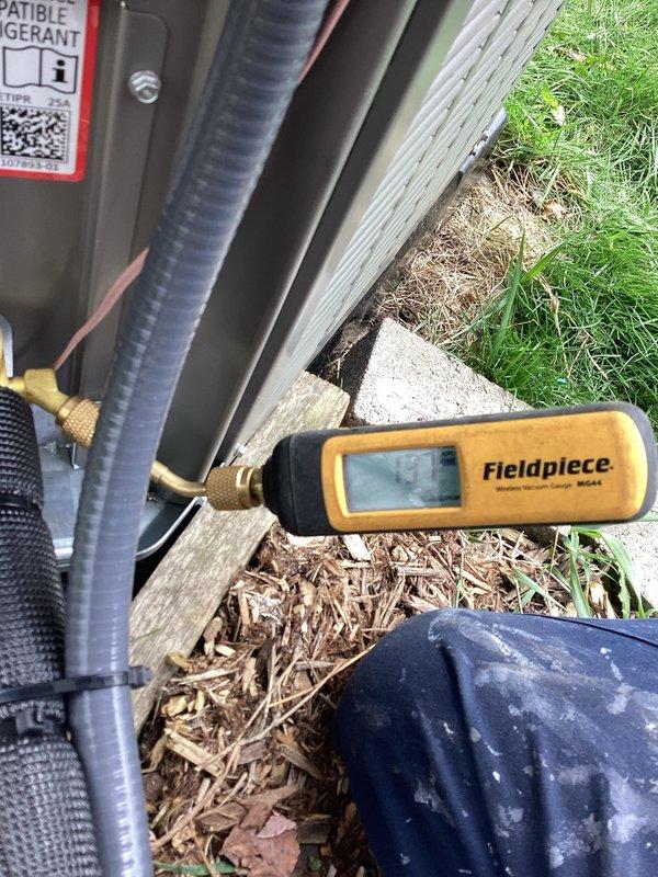 Completed return visit to finalize A/C installation following previous work. Ran 7/8" lineset with proper boots, installed new breaker, connected disconnect and whip, and ran low voltage wiring to complete A/C system connection. System tested and verified operational with Fieldpiece gauges confirming proper refrigerant pressures on newly installed Lennox condenser unit.