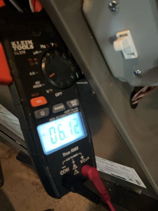 Completed scheduled air conditioning maintenance on residential cooling system. Performed electrical diagnostics using digital multimeter, recording voltage reading of 6.12V at control circuit. Measured operating amperage of unit at 16.6 amps using clamp meter at compressor circuit. Inspected internal electrical components, wiring connections, and control board within outdoor condensing unit. Verified proper wire terminations and cable management. System operational upon completion of maintenance inspection.