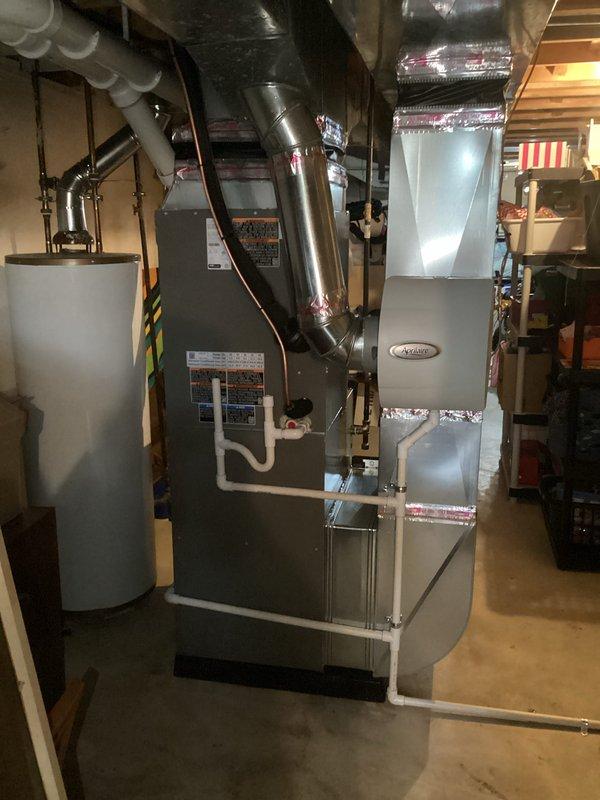 Completed full HVAC system installation including a 90,000 BTU furnace and 3.5 ton air conditioning unit with rear discharge configuration. Installed furnace on platform base in basement mechanical room with proper ductwork connections, reflective insulation, and metallic supply plenum extending to ceiling joists. Reconnected all existing electrical and mechanical connections, installed Aprilaire equipment integration, and secured all ductwork with appropriate strapping and supports. Mechanical and electrical permits were obtained prior to installation, and all work was completed to code specifications with proper clearances maintained around water heater and other existing utilities.