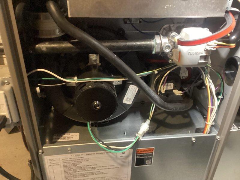 Completed annual furnace maintenance and tune-up on residential heating system. Performed comprehensive inspection of all internal components including blower motor assembly, heat exchanger, electrical connections, and safety controls. Verified proper operation of pressure switches, sensors, and condensate drainage system. All colored wiring connections inspected and confirmed secure. Blower motor and fan assembly checked for proper function. System tested and confirmed operating within manufacturer specifications with no issues identified.