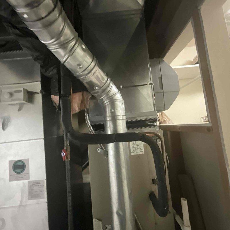 Completed comprehensive estimate for replacement of 20-year-old air conditioning system. Evaluated existing Lennox furnace installation and associated ductwork infrastructure in basement mechanical room, documenting current system configuration including metal supply plenum, galvanized ductwork, and PVC condensate drainage. Photographed equipment layout and existing HVAC components to provide accurate replacement specifications for aging AC unit that has reached end of serviceable life.