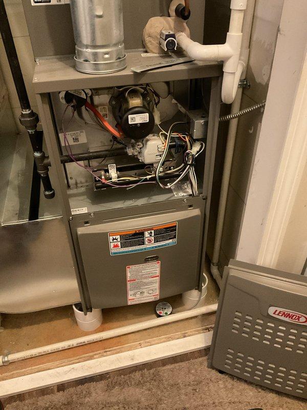 Completed annual heating maintenance and tune-up on residential furnace system as part of membership program. Performed comprehensive inspection of furnace unit with access panel removed to evaluate blower motor, electrical connections, and internal components. All wiring connections, including red, white, yellow, and black conductors, were inspected and found secure. Blower motor assembly, terminal blocks, and safety controls verified operational. System found in proper working condition with no issues identified.