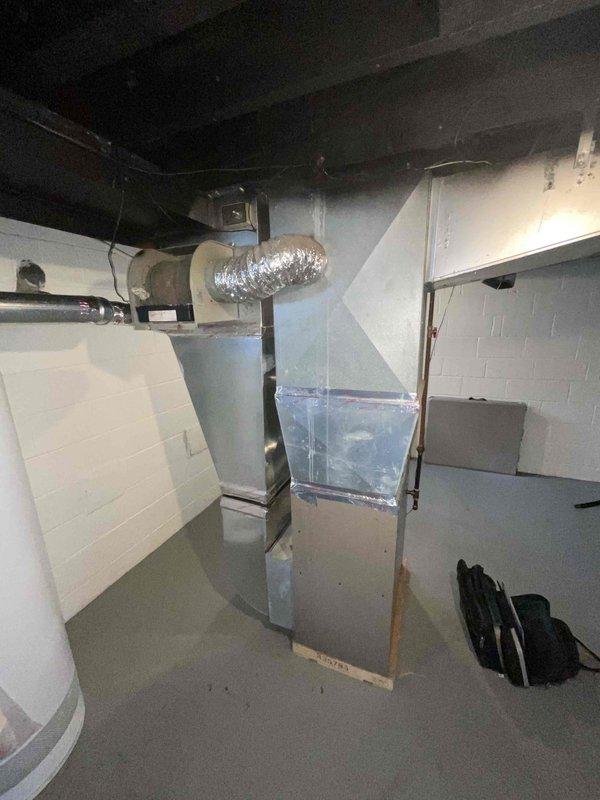 Provided estimate for new air conditioning system installation to work in conjunction with existing 2-year-old natural gas furnace located in basement mechanical room. Assessed current HVAC infrastructure including ductwork, plenum connections, and available space for outdoor condensing unit placement. Documented existing furnace setup and determined compatibility requirements for integrated cooling system addition.