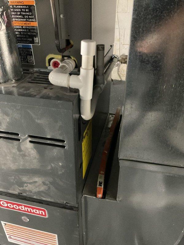 Completed installation of 2-ton Goodman air conditioning system with matching evaporator coil in residential basement location. Installation included new outdoor condensing unit with rear discharge configuration, indoor A-coil mounted to existing furnace, refrigerant line set with proper insulation, condensate drainage system with PVC piping, and dedicated electrical circuit with disconnect. All refrigerant lines were properly brazed, pressure tested, and evacuated before charging system to manufacturer specifications. System was commissioned and tested for proper operation, airflow, and temperature differential across coil. Mechanical, electrical, and air conditioning permits were obtained prior to installation.