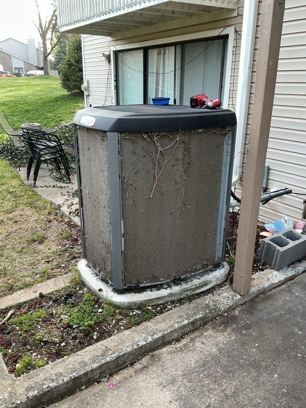 Completed routine AC clean and check on residential R410A system. Upon arrival, found outdoor condenser unit heavily clogged with dirt, debris, and organic material coating exterior surfaces and coil fins, with vines draped across unit face. Performed thorough cleaning of condenser coil and exterior housing to restore proper airflow. Checked system operating pressures and temperatures using refrigerant manifold gauge, recording 113.3 psig suction pressure and 258.4 psig discharge pressure with superheat at 142°F and subcooling at 144°F. System operating within acceptable parameters following cleaning. Unit restored to proper operating condition.