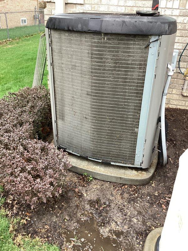 # HVAC Maintenance - ACM Completed

Performed routine air conditioning maintenance on residential outdoor condenser unit positioned against exterior brick wall. Conducted comprehensive system inspection including visual assessment of cabinet condition, refrigerant line connections, and electrical components. Unit showed signs of normal weathering with accumulation of dirt and debris on exterior fins and louvers. Verified concrete pad stability and proper unit positioning. Checked condenser coil condition and airflow through horizontal louvers. Inspected protective fan grille cover and confirmed secure mounting. Examined copper tubing connections and electrical line routing on right side of unit for any visible damage or wear. System operational and ready for continued cooling service.