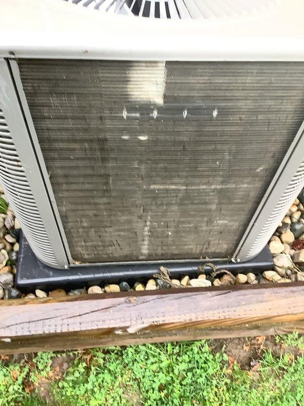Performed annual cooling maintenance on outdoor condensing unit. Upon arrival, found condenser coils heavily contaminated with dirt, dust, and environmental debris causing significant airflow restriction. Cleaned and straightened condenser fins, removed accumulated grime from exterior panels, and verified proper unit operation. System tested and confirmed operating within normal parameters following maintenance completion.