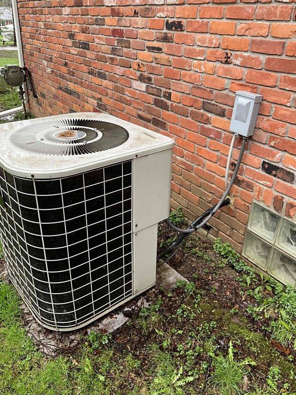 Conducted estimate for complete air conditioning system replacement. Existing outdoor condenser unit is approximately 30 years old, dating back to 1990s installation, showing significant age-related wear and deterioration. Indoor furnace system with attached humidifier located in basement utility area exhibits moisture damage evidenced by white mineral deposits and efflorescence streaking down unit sides. Evaluated current system configuration including ductwork connections, electrical service, and equipment placement. Documented equipment conditions through photographic assessment of both indoor and outdoor components. Provided recommendations for new AC system installation to replace aging equipment that has exceeded typical service life expectancy.