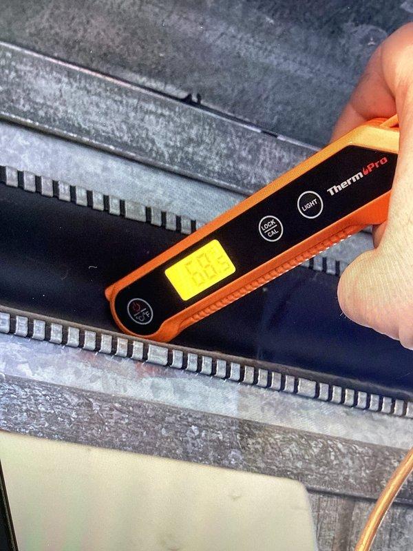 Responded to no cooling call with outdoor unit iced up. Upon arrival, found evaporator coil frozen with significant ice buildup on refrigerant lines and exterior components. Used digital thermometer to verify temperature differentials across system components. Inspected electrical connections at condensing unit, noting all wire terminations secure with proper insulation caps. Documented coil condition and wiring configuration. System requires thawing before further diagnostics can be performed to determine root cause of freezing condition, which may include low refrigerant charge, restricted airflow, or failed blower motor. Recommended follow-up service after ice melts to complete refrigerant pressure testing and airflow measurements.