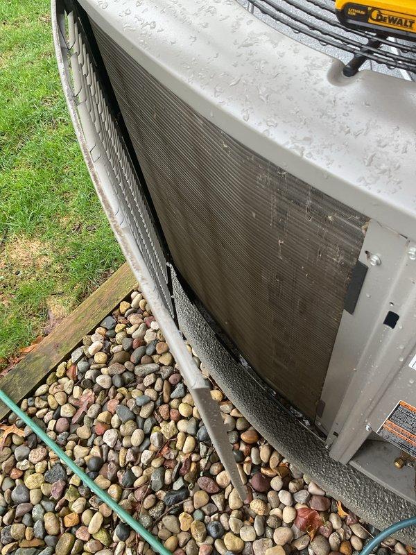 Completed annual air conditioning maintenance on residential split system. Customer clarified system configuration includes boiler for heating with separate air handler and outdoor condensing unit for cooling purposes. Performed comprehensive inspection of outdoor unit, verified proper placement on gravel pad with adequate clearance, and confirmed structural integrity of cabinet and protective grilles. Documented equipment condition showing normal weathering consistent with outdoor exposure. System operational and ready for cooling season.