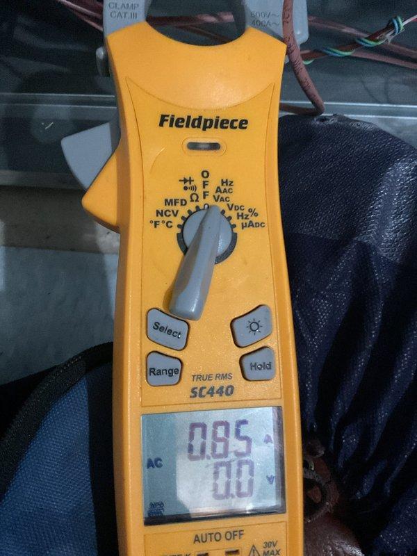 Completed scheduled Air Care Cooling maintenance on residential air conditioning system. Performed standard ACM inspection including electrical testing with clamp meter, which confirmed proper amperage draw at 0.95 amps. Inspected outdoor condenser unit, noting darkened and debris-laden condenser coils requiring attention, though unit remains operational with adequate airflow through top-mounted fan assembly and side louvers.
