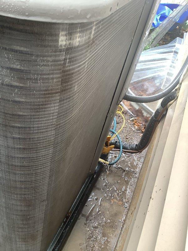 Completed annual cooling maintenance on residential air conditioning system. Performed comprehensive inspection of outdoor condenser unit, which showed significant accumulation of dirt, debris, and organic matter on exterior surfaces and surrounding installation area. Cleaned condenser coils, removed debris from unit base and adjacent spaces, verified refrigerant line connections, and confirmed proper drainage function. Unit operational and ready for cooling season.