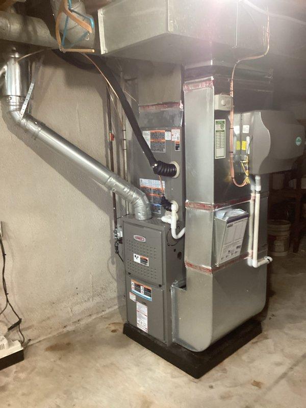 Completed full HVAC system installation including new air conditioning unit and evaporator coil in basement mechanical room. Connected refrigerant lines to existing furnace plenum, installed flexible aluminum ductwork, and integrated all electrical and condensate drainage components. System tested and verified operational with all connections secured and permits obtained per code requirements.