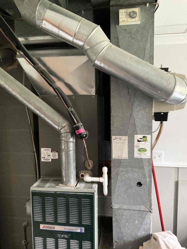 Provided estimate for new mini split installation in garage being converted to bedroom. Evaluated existing 30-year-old furnace system currently located in laundry room and operational, with ductwork and air handler configuration documented for integration planning with proposed ductless system.