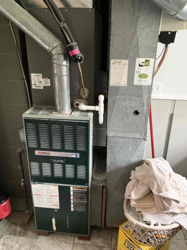 Provided estimate for new mini split installation in garage being converted to bedroom. Evaluated existing 30-year-old furnace system currently located in laundry room and operational, with ductwork and air handler configuration documented for integration planning with proposed ductless system.