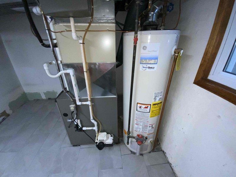 Completed full system replacement estimate for 25-year-old air conditioning system. Inspected existing HVAC equipment in basement utility room, documenting current furnace and outdoor unit condition with detailed photography showing significant age-related wear, dust accumulation, and outdated components. Provided comprehensive replacement quote and confirmed preference for text message communication regarding estimate follow-up.