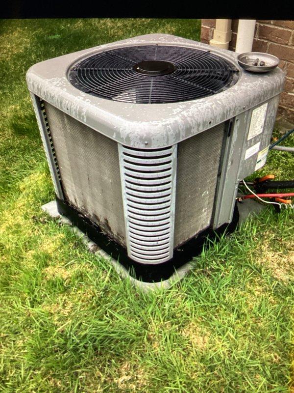 Completed annual cooling maintenance on residential outdoor condensing unit. Performed comprehensive system inspection, documenting equipment condition with unit showing typical weathering and dirt accumulation on cabinet surfaces and louvers. Verified proper operation of condenser fan and assessed overall system functionality during scheduled maintenance visit.