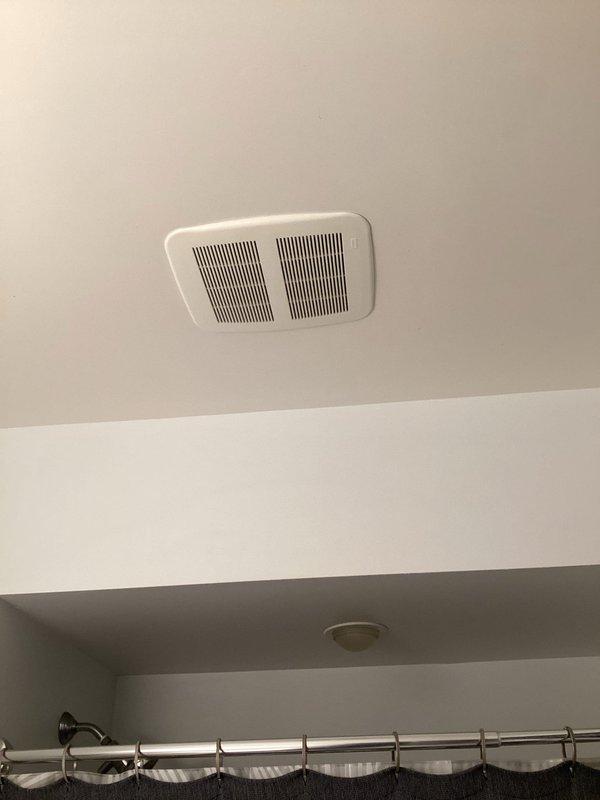 Responded to customer concern regarding bathroom exhaust fan allowing cold air infiltration when both on and off. Inspected ceiling-mounted ventilation unit and electrical connections. Identified improper damper operation allowing exterior air backflow through vent housing. Verified wiring connections were secure and fan motor functioning correctly.