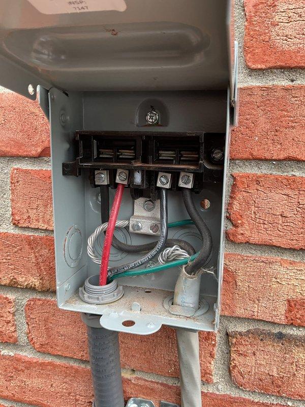 Responded to service call for 2-year-old outdoor A/C unit displaying error code 434 and "SERVICE URGENT" message when thermostat was adjusted. Upon arrival, inspected outdoor disconnect box and found loose electrical connections at terminal block. Tightened all wire connections including red, white, black, and ground wires at terminal screws. Verified proper voltage at disconnect, closed enclosure, and tested system operation. Unit powered on successfully with no error codes displayed. Work completed under parts and labor warranty.
