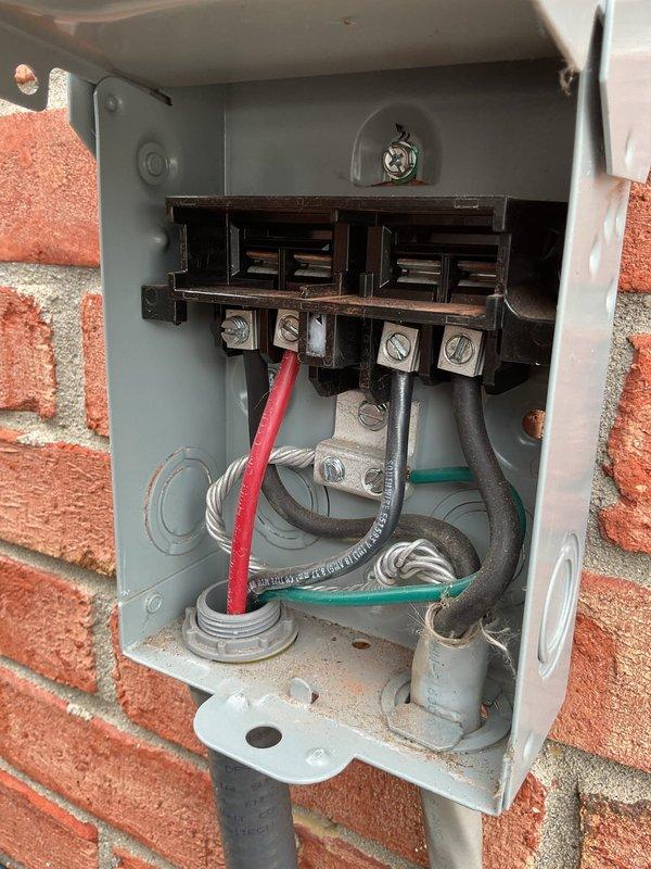 Responded to service call for 2-year-old outdoor A/C unit displaying error code 434 and "SERVICE URGENT" message when thermostat was adjusted. Upon arrival, inspected outdoor disconnect box and found loose electrical connections at terminal block. Tightened all wire connections including red, white, black, and ground wires at terminal screws. Verified proper voltage at disconnect, closed enclosure, and tested system operation. Unit powered on successfully with no error codes displayed. Work completed under parts and labor warranty.