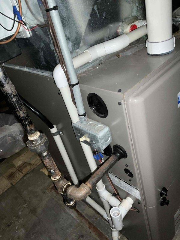 Responded to service call for intermittent furnace and air conditioner operation following multiple failed repair attempts. Conducted comprehensive evaluation of existing Wolf furnace and air conditioning system in residential basement mechanical room. Documented current equipment condition through photographs, noting aging infrastructure including corroded metal piping, older ductwork with moisture accumulation, and mixed plumbing components combining newer PVC with deteriorated metal connections. Assessed heating unit access panel, internal wiring, venting configuration, and air handler assembly to determine system viability. Prepared replacement estimate for complete HVAC system due to repeated equipment failures and end-of-service-life conditions. Provided paper documentation as requested and coordinated communication protocols for property access.