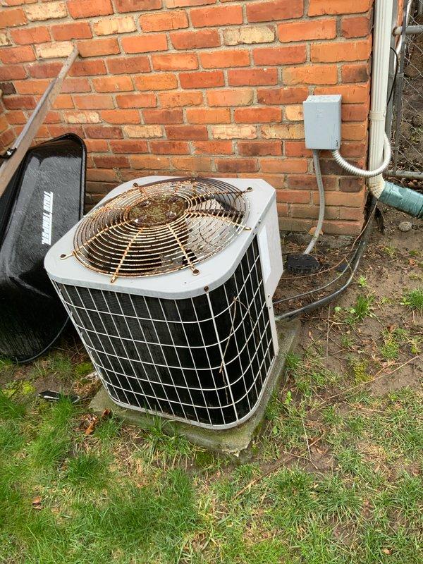 Provided comprehensive estimate for complete HVAC system replacement including both air conditioning condenser and natural gas furnace. Existing 26-27 year old equipment remains operational but has reached end of service life. Assessed basement installation with confined space considerations for furnace replacement and evaluated outdoor condenser unit positioned on concrete pad against exterior brick wall with existing refrigerant line routing and electrical disconnect configuration.