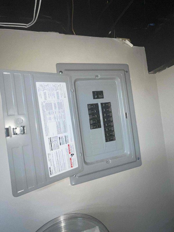 Conducted estimate for new air conditioning system installation in basement location with no existing equipment. Documented existing natural gas furnace and electrical panel configuration. Observed severe evaporator coil icing on current HVAC equipment, indicating potential refrigerant issues or airflow restrictions. Photographed ductwork layout, electrical service panel, and equipment placement to prepare comprehensive replacement proposal for complete AC system installation.