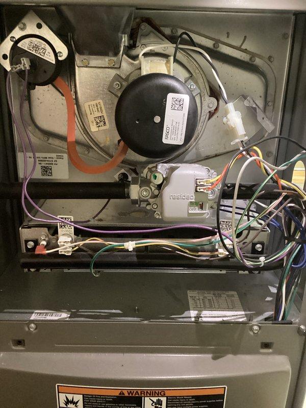 Completed annual furnace maintenance and tune-up on residential heating system. Performed comprehensive inspection of all internal components including blower motor assembly, gas burners, electrical connections, and control systems. Verified proper ignition sequence with burners displaying optimal blue flame pattern. Inspected all wiring connections, safety switches, and circuit boards for secure operation. All components found to be in excellent working condition with system operating within manufacturer specifications. Unit photographed and documented for service records.