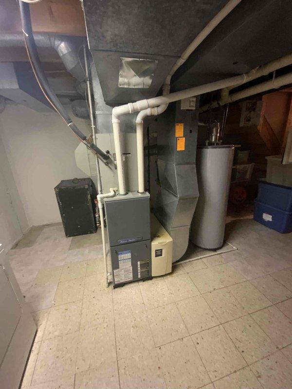 Conducted estimate for air conditioning system replacement. Existing unit is 21 years old, completely flat on refrigerant, and beyond economical repair. Inspected basement utility area housing furnace, ductwork, and associated HVAC infrastructure to assess compatibility and requirements for new AC installation. Customer seeking immediate replacement due to system failure and age of equipment.