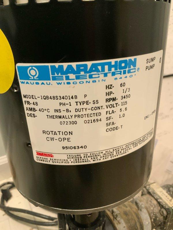 Conducted site evaluation for sump pump replacement in a 1979-built residential property. Assessed existing Marathon Electric 1/3 HP, 115V sump pump unit (Model 1QB48S34014B) currently installed in basement utility area adjacent to carpeted living space. Documented current pump specifications, discharge piping configuration, and electrical connections to provide accurate quote for new sump pump installation.